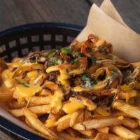 Philly Style Fries · Grilled onions &  pickled sweet peppers, topped with Cheese Whiz