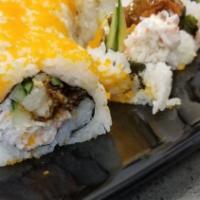 Dragon Roll · Inside: Shrimp, tempura, cucumber, crab meat.
Top: Avocado, eel. with sauce