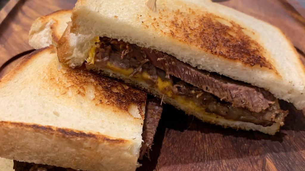 Grilled Brandt Beef Brisket & Cheese · Dry rub smoked brisket, cheddar, sourdough bread. Served with chips.