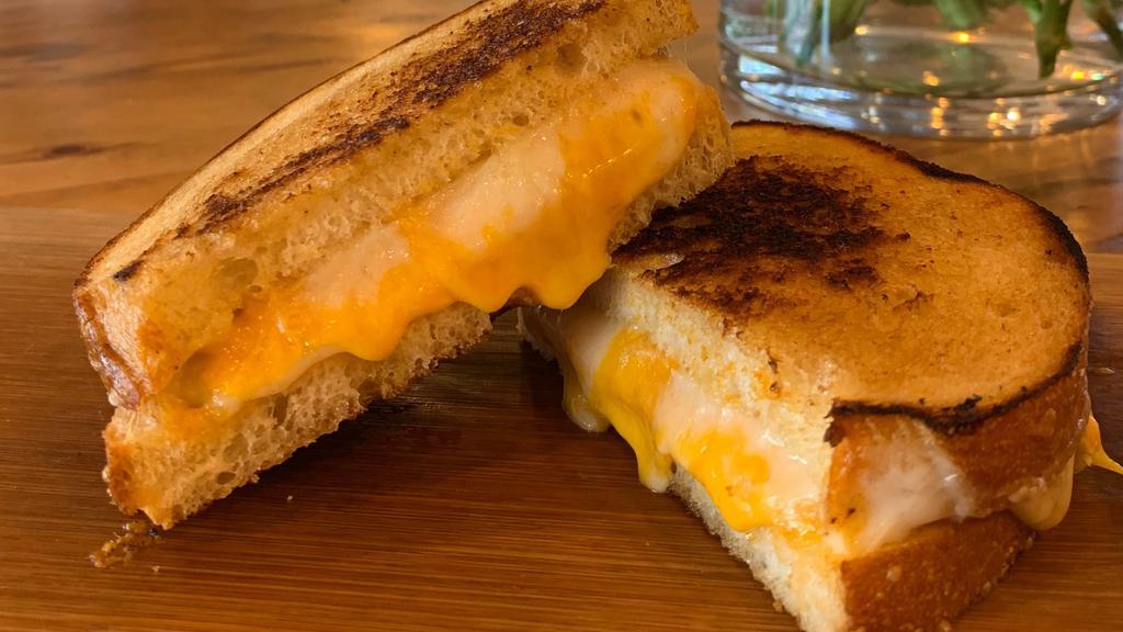 Grilled Cheese & Tomato · Cheddar, swiss, tomato, sourdough. Served with chips.