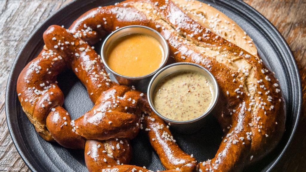 Stone Delicious Bavarian Pretzel · All natural artisan hand rolled jumbo pretzel made with Stone Delicious IPA  served with IPA mustard and beer cheese.