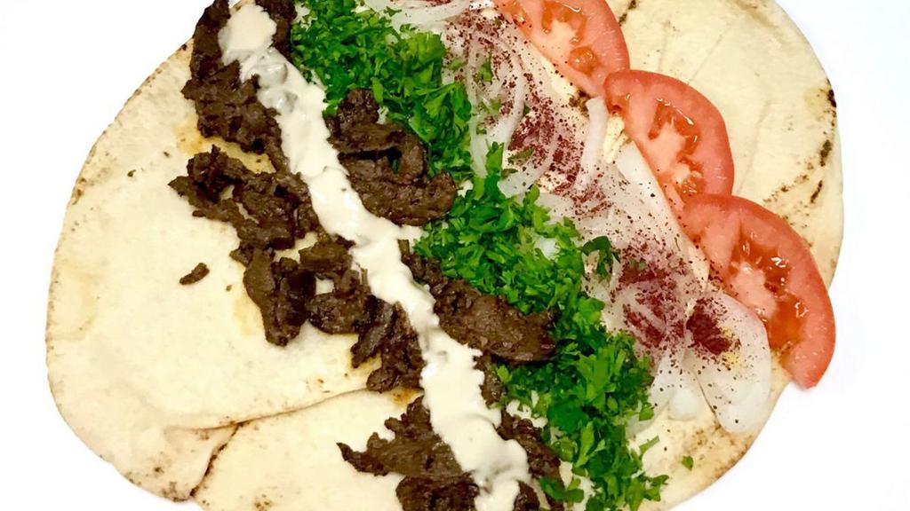 Beef Shawarma Wrap · Served with tomatoes, parsley, onions, sumac, and tahini sauce.