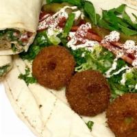 Falafel Wrap · Vegetarian. Served with parsley, lettuce, tomatoes, mint leaves, pickles, and tahini sauce.