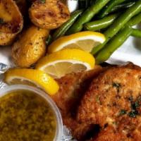 Lemon Butter Chicken · A plate of Parmesan-crusted chicken, pan-seared until golden, served with garlic-herb roaste...