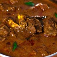 Spicy Goat Curry · Goat curry spiced with dried red chilies and flavored with an authentic homemade masala.