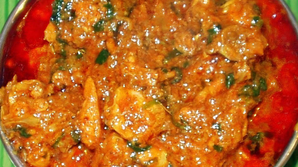 Andhra Kodi Kurra · Andhra style chicken curry with traditional spices and herbs.