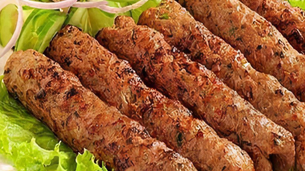 Mutton Seekh Kabab · Minced lamb marinated and cooked in tandoor and tossed with sauce.