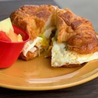 Breakfast Sandwich · Turkey or bacon, 2 eggs, cheese, avocado on a buttery croissant.