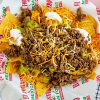 Super Nachos · Chips with carne asada, guacamole, sour cream and cheese.