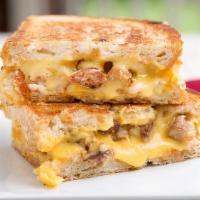 Sausage Egg And Cheese Sandwich  · 2 patties of sausage egg and cheese. Request for sauce if you would like.