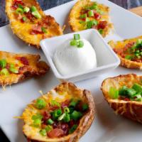 Loaded Potato Skins · Six fried handmade potato skins, loaded with melted cheese, bacon, chives. served with sour ...