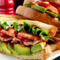 California Blt · Maple Bacon, lettuce, tomatoes, over hard egg inside of Brioche bread with sliced avocados.S...