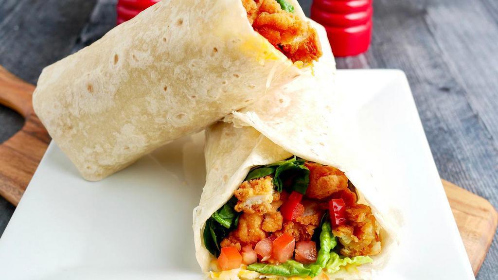 Crispy Chicken Wrap · Two crispy chicken tenders chopped, roasted bell peppers, lettuce, tomatoes and shredded cheese with your dressing of choice, wrapped in a 14″ flour tortilla.