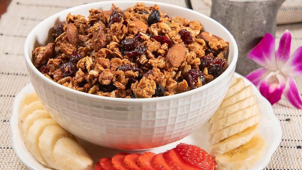 Urth Granola™ Bowl · Oven-roasted organic oats, almonds, sun-dried blueberries & cranberries with pumpkin & sunflower seeds sweetened with honey, spices & pure maple syrup. Served with your choice of milk.