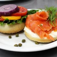 Lox Breakfast Bagel Sandwich · Toasted bagel, lox, cream cheese, red onion, tomatoes, spinach, capers.