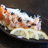 Salmon Carpaccio · Salmon sashimi arranged in creamy sesame sauce and topped with flying fish roe.