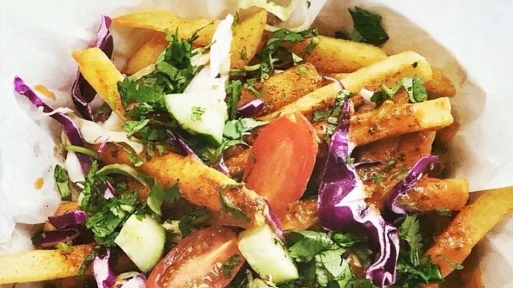 Masala Fries · Fries served with creamy masala sauce, optionally garnished with cilantro, green onions, and red cabbage.   Sauce comes prepared mild, let us know your spice level).