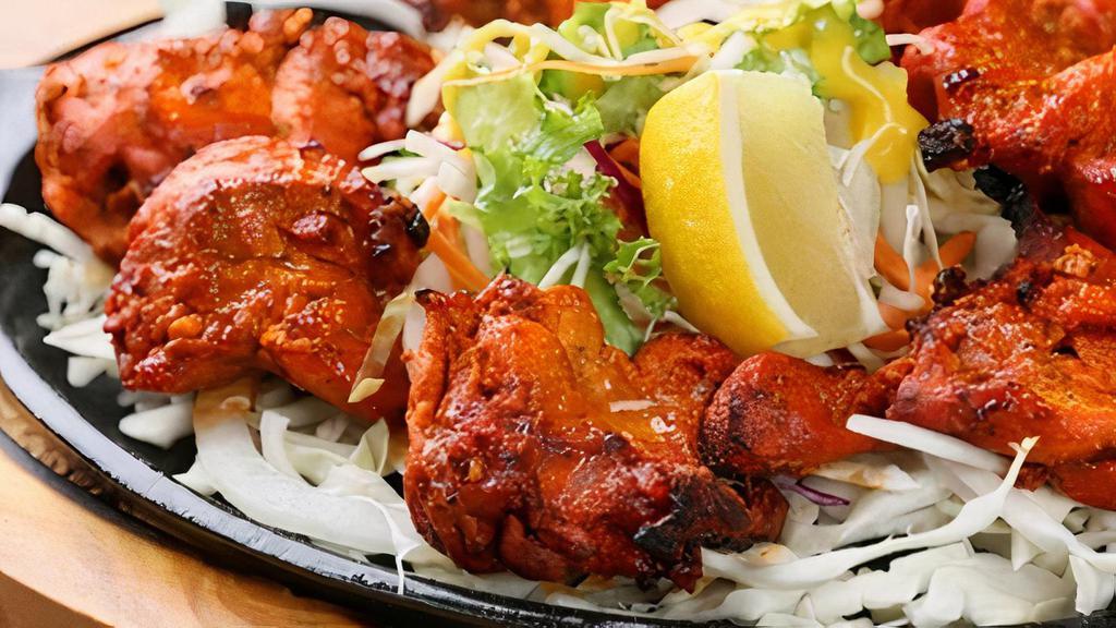Grilled Chicken Tikka · Boneless chicken coated in a special yogurt marinade served with onions and green peppers on a sizzler.  ( let us know your spice level - mild , med., or spicy)