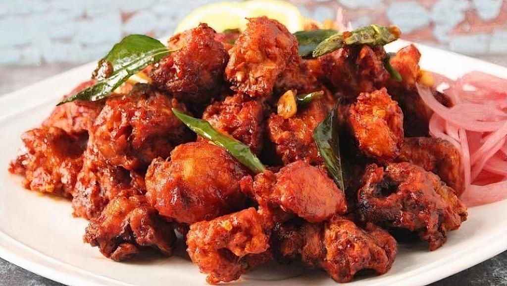 Chicken 65 · Boneless deep-fried chicken cooked with green peppers, onions and chili sauce with a hint of lemon/soy sauce flavor.