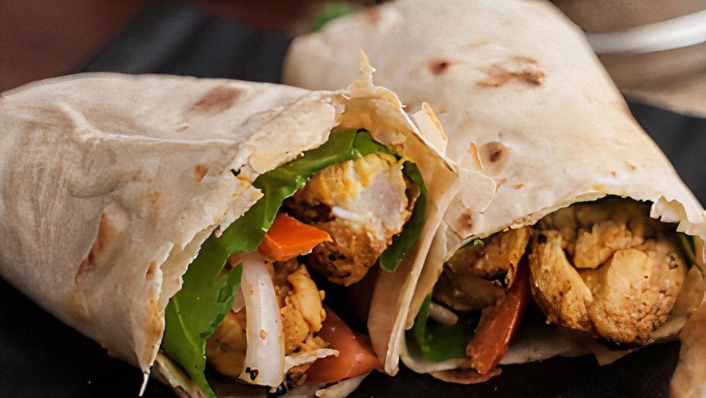 Grilled Chicken Tikka Wrap · Chicken grilled in a Tandoor, served on a tortilla with lettuce, tomato, cilantro, cucumbers, and creamy mint chutney.