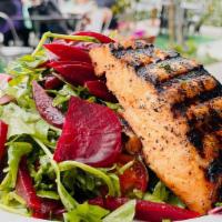 Salmon & Beet Salad · Freshly grilled 7oz salmon on a bed of organic arugula with heirloom tomatoes, beets, red on...