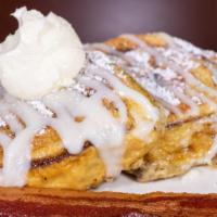 Cinnamon Swirl French Toast Combo · Two cinnamon rolls grilled french toast style & two eggs with two strips of bacon.