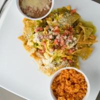 Chilaquiles  · Tortilla chips sauteed in red or green salsa,. then topped with scrambled egg, cotija cheese...