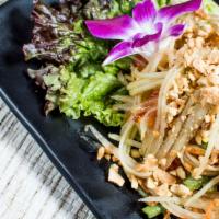 Green Papaya Salad (Som Tum) · A Thai eastern style green papaya salad with tomato, green bean, a touch of garlic, lime jui...