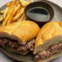 French Dip Sandwich · Certified Angus Beef, roasted and thinly sliced on a grilled roll, served with home-made au ...