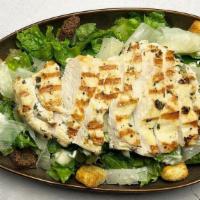 Fire-Grilled Chicken Caesar · Crispy romaine with shaved Parmesan cheese and crunchy croutons, topped with sliced, hot-off...