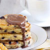 Nutella Pancakes · Airy, fluffy and delicious flavored pancakes with strawberry, banana, blueberry, and powdere...