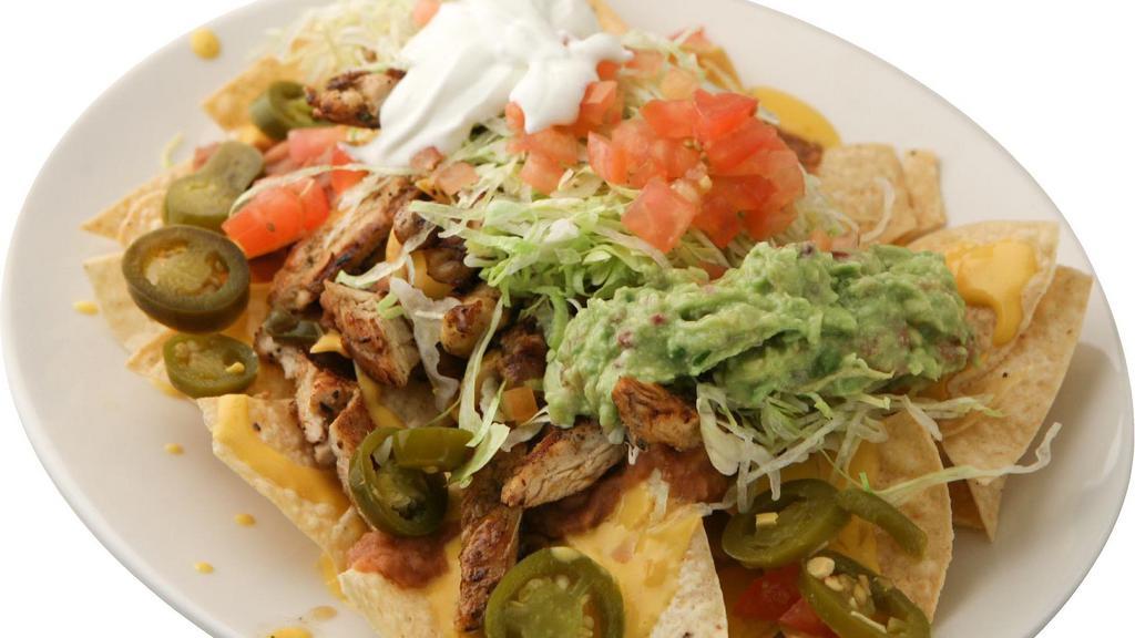 Super Nachos · Carne Asada or Chicken, Cheese, Beans, Lettuce,Tomatoes, Sour Cream, Guacamole and Jalapeños