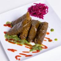 Dolmades (5) · Vine leaves stuffed with basmati rice, herbs and spices.