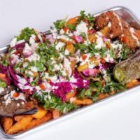 Street Style Sweet Potato Fries · Sweet potato fries loaded with eggplant, fried jalapenos, chickpea croutons, kale salad, pic...