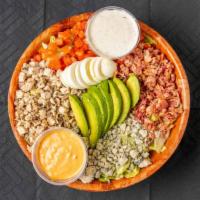 Cobb Salad · Iceberg lettuce topped with chicken, tomatoes, bacon, Bleu cheese crumbles, boiled eggs, and...