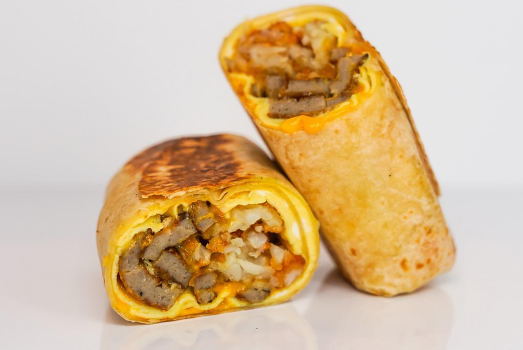 Impossible Sausage, Egg, & Cheddar Breakfast Burrito · Delicious vegetarian option for your savory breakfast burrito. 3 fresh cracked, cage-free scrambled eggs, melted Cheddar cheese, seared Impossible sausage patties, and crispy potato tots wrapped in a toasted 12” flour tortilla. Comes with avocado salsa verde side.