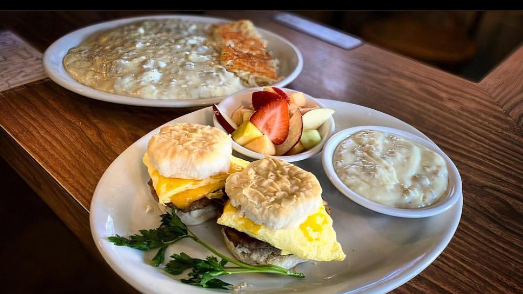 Breakfast Sliders · Two biscuit sandwiches with sausage patties, scrambled eggs, and cheddar cheese. Served with a side of sausage gravy.