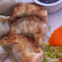 Dumplings · Eight pieces. Hand-made chicken dumplings. Served pan fried or steamed with our sweet ginger...
