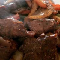 Hong Kong Black Pepper Steak · Marinated filet mignon tossed with onions and bell peppers in a black pepper sauce.