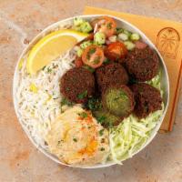 Falafel Rice Bowl · Crispy falafel over basmati rice with hummus, Greek salad, and shredded green cabbage.