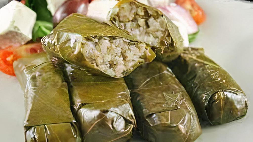 Grape Leaves · Two grape leaves stuffed with rice and lemon.