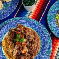 Carnitas Plate · 24 hour marinated pork slow cooked till tender, mexican rice, seasoned pinto beans, and a sp...