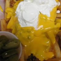 Nacho  Fries · Nacho cream cheese sauce over French Fries with Flavorfully seasoned ground beef and sour cr...