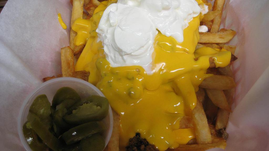 Nacho  Fries · Nacho cream cheese sauce over French Fries with Flavorfully seasoned ground beef and sour cream added, 2-oz cup of jalapeno