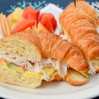 Swiss Sandwich · Served with choice of hash brown or fresh seasonal fruit. Croissant filled with scrambled eg...