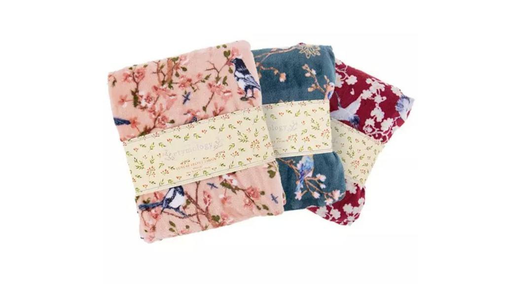 Floral Print Velvet Throw · Bundle up with this plush oversized throw blanket! Each blanket features a thick, luxurious fabric that feels soft and soothing against the skin. Toss it over a sofa or chair for casual flair, so it's handy when you are ready to snuggle. Available in an assortment of floral styles.
