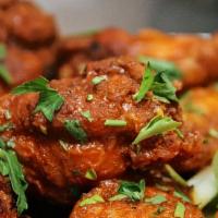 Buffalo Wings · Eight wings, spicy sauce, ranch, carrot and celery spears.
