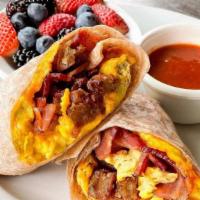 Breakfast Burrito · Eggs scrambled with diced potato pancakes, bacon, cheddar cheese, and wrapped in a whole whe...