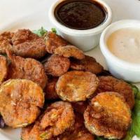 Fried Pickles · Dill pickle chips battered, deep-fried, and served with two sauces: ranch and tangy BBQ.  Ve...