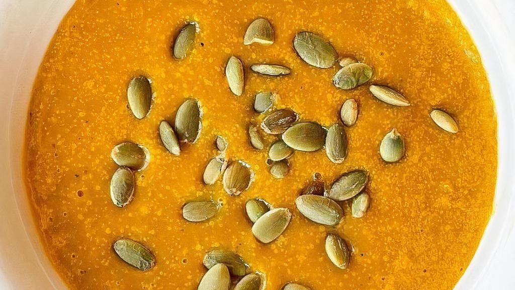 Butternut Squash Soup · Roasted butternut squash blended with organic carrots & celery, onions, garlic, fresh thyme, almond milk, and a hint of curry. Topped with toasted pumpkin seeds.  Vegan, vegetarian, and gluten free. Contains nuts.